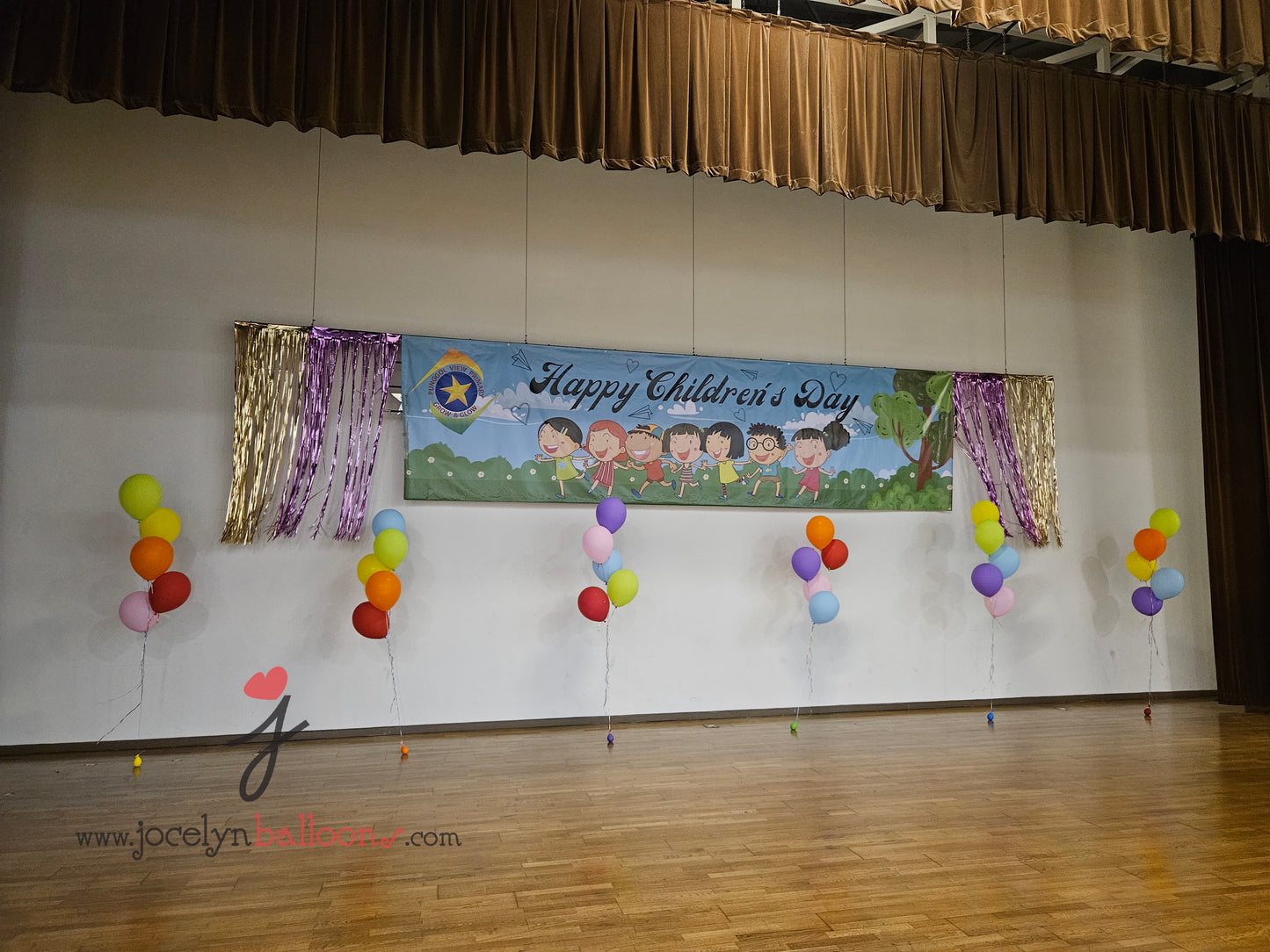A Pair of Balloon Columns with Balloon Sculpture School Boy & School Girl