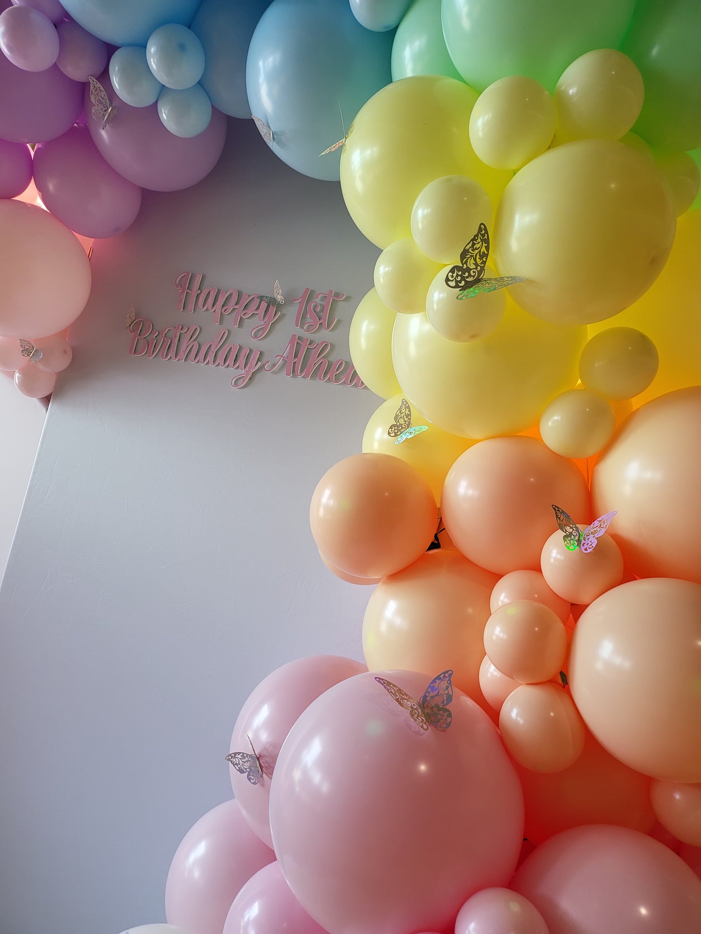 Pastel Organic Rainbow Balloon Garland with Cascading White Fabric Backdrop