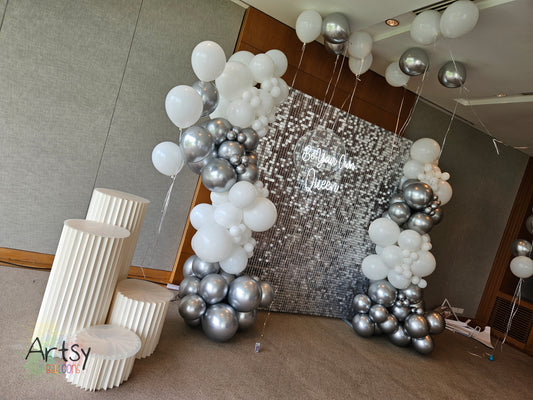 Silver Shimmer Backdrop with Organic Balloon Garland, Paper Plinth, LED Signage and Helium Balloon
